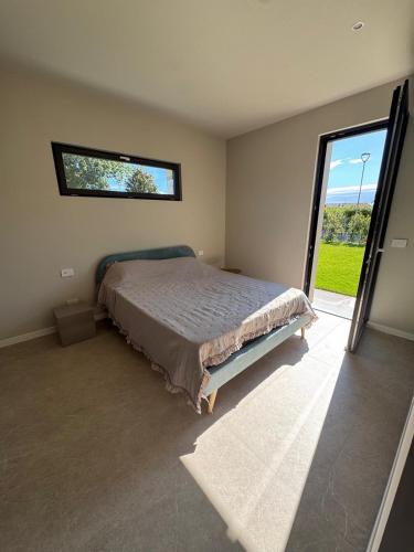 a bedroom with a bed and a large window at Villa Grace in Padenghe sul Garda