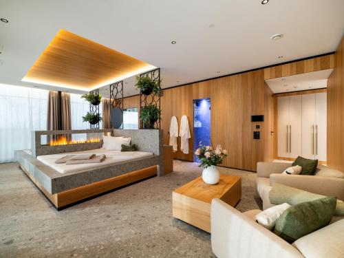 a bedroom with a large bed and a living room at Hotel von Rotz in Wil