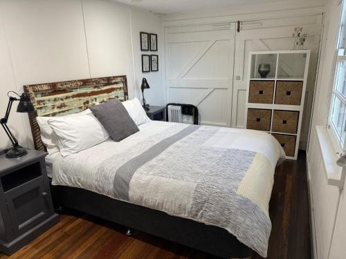 a bedroom with a large bed and a window at Boatsheds in Sawtell