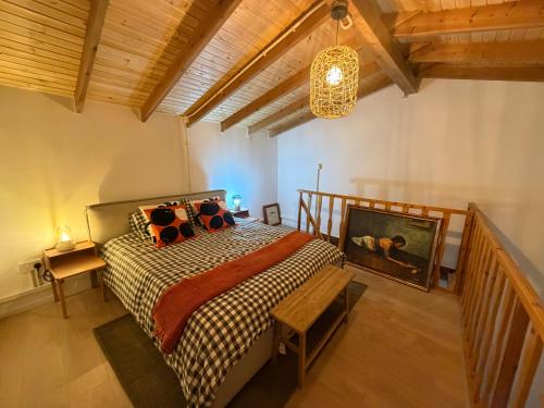 a bedroom with a bed and a chandelier at Melograno Lofou in Lofou