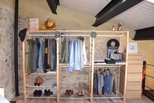 a shelf with clothes and shoes in a room at El Loft de Can Padrosa in Riumors