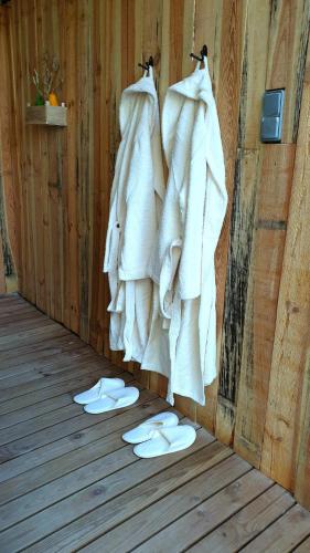a group of white towels hanging on a wall at El Loft de Can Padrosa in Riumors