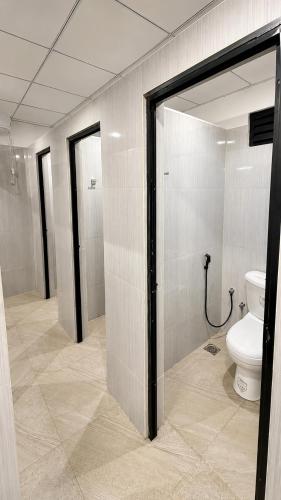 a bathroom with a toilet in a room at Wave Hostels Arugam Bay - With Swimming Pool in Arugam Bay