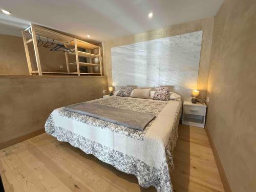 a bedroom with a large bed in a room at Can Padrosa Mini loft 4 in Riumors