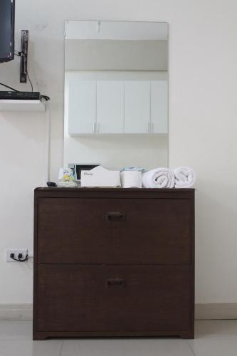 a wooden cabinet with towels on top of it in a kitchen at RESIDENCIA SAN VICENTE - PASAY -Budget Hotel in Manila