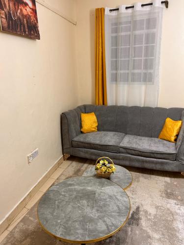 a living room with a couch and a table at Victory homes in Eldoret