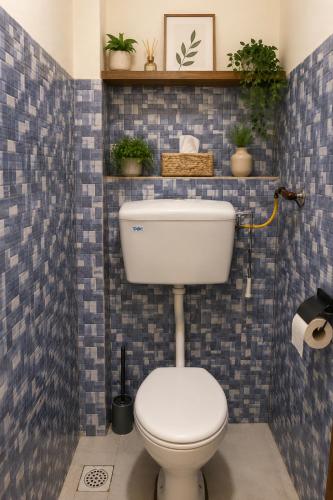 a bathroom with a white toilet and blue tiles at Victory homes in Eldoret