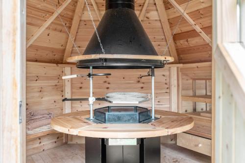 a stove in a wooden sauna with a ceiling at Jäckleshof in Sankt Georgen im Schwarzwald