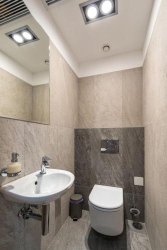 a bathroom with a sink and a toilet at Hotel Elanza Suites by Signature Stayz Near Delhi Airport in New Delhi