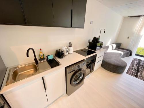 a kitchen with a sink and a washing machine at 42 on Kavango Unit 17 in Khomas Region