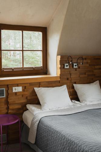 a bedroom with a large bed and a window at HOT_elarnia Hotel & Spa in Puszczykowo