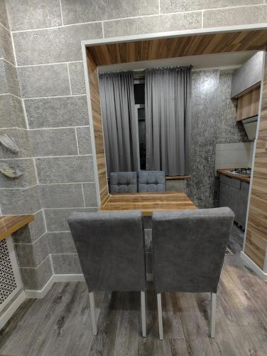 a dining room with a table and two chairs at Apartments in Taraz