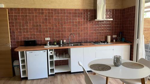a kitchen with a sink and a table with chairs at Can Padrosa Mini Loft 2 in Riumors