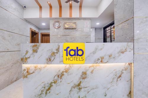 a sign on a marble counter in a lobby at FabHotel Shaurya Inn MIDC in Ghansoli