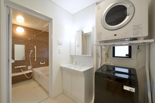 a small bathroom with a sink and a microwave at 北谷町港2 in Chatan