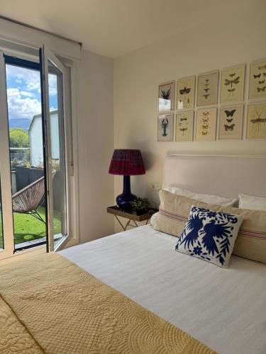 a bedroom with a bed and a window with a view at Apartamento Loiola in Azpeitia