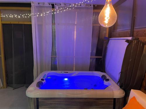 a blue bath tub in a room with a light at Can Padrosa Mini Loft 1 in Riumors