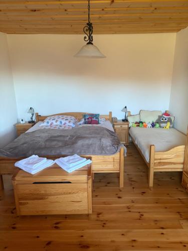 a bedroom with a bed and a table with two twin beds at Chalupa v prírode in Pliešovce