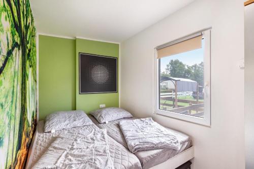 a bedroom with two beds and a window at Ferienhaus 36 in Zadelsdorf