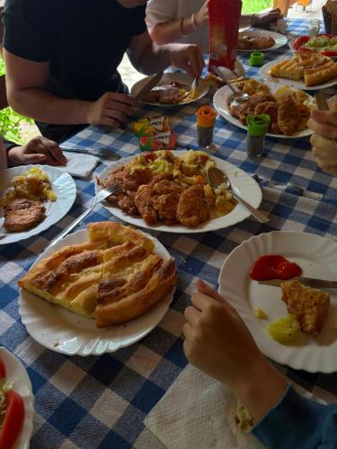 a table with plates of food on top at Wildas Cabins, Tara River Canyon in Foča