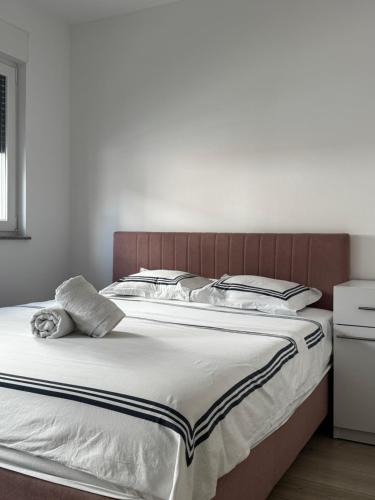 a bedroom with a large bed with a wooden headboard at Villa Hodžić in Mostar