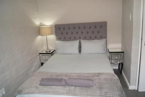 a bedroom with a large bed with two night stands at Chalet Kudu in Ladismith