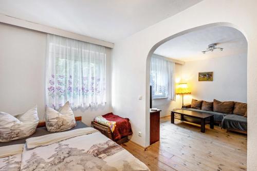 a bedroom with a bed and a couch in a room at Ponyhof Kudowa in Sonnewalde