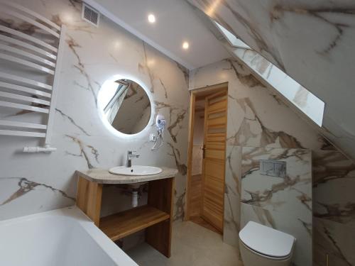 a bathroom with a sink and a mirror at Domek u Szwajnosów in Ciche