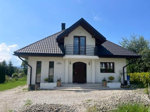 a white house with a black roof at Villa Anna in Nowy Targ