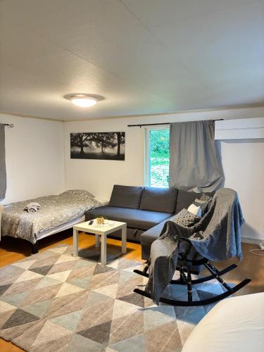 a living room with a couch and a bed at Garden View vacation home in Granna in Gränna