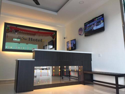 a living room with a tv and a fireplace at Hi Star Hotel in Sitiawan