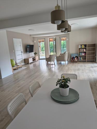 a dining room and living room with a table and chairs at Villa Anna in Nowy Targ