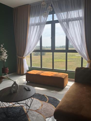 a living room with a bed and a large window at klebang Beachfront Homestay I Snooker I Massage Chair I Pool in Malacca
