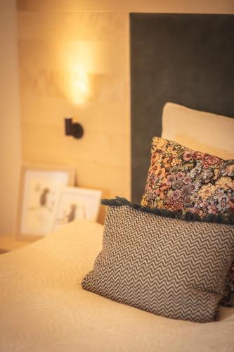 a bed with two pillows sitting on top of it at das Ebner in Stubenberg