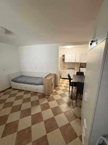 a room with a bed and a table in it at Apartma Studio Enej Piran in Piran