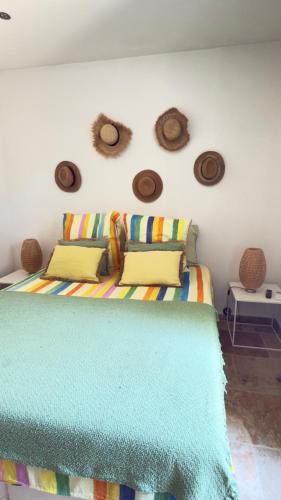 a bedroom with a bed and some hats on the wall at La Largarde in Six-Fours-les-Plages