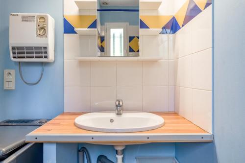 a bathroom with a sink and a mirror at Gite les Mazets du Rouret in Saint-Christol-lès-Alès