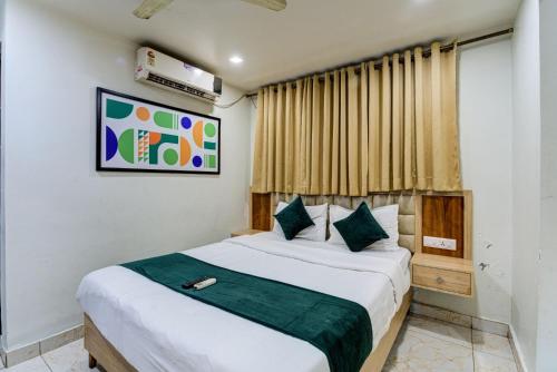 a bedroom with a large bed in a room at Hotel Elmas in Bangalore
