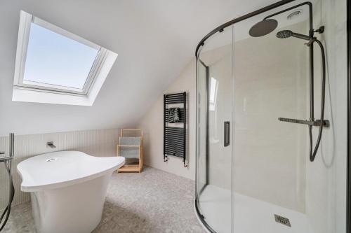 a bathroom with a toilet and a glass shower at Seaddler in Holyhead