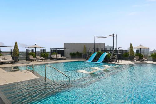 a swimming pool with a slide in a hotel at Dusit Princess Melaka in Malacca