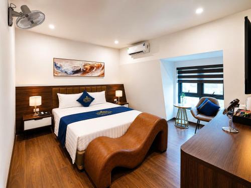 a bedroom with a bed and a desk with a chair at A3 Villa Hotel - Gia Lâm in Thạch Cầu