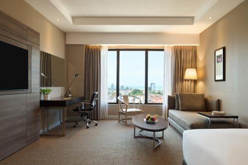 a living room with a couch and a table at Dusit Princess Melaka in Malacca