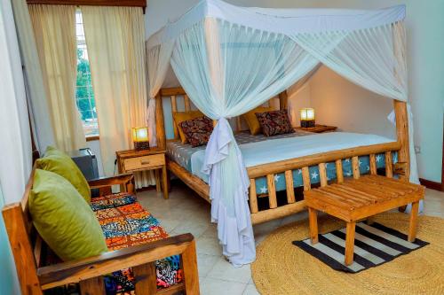 a bedroom with a bed with a canopy at City Villa in Arusha