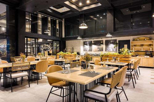 a restaurant with tables and chairs in a room at JET Hotel Lipa City in Lipa