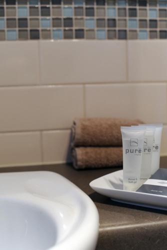 a bathroom with a sink and a cup on a counter at Ballarat Central City Motor Inn in Ballarat
