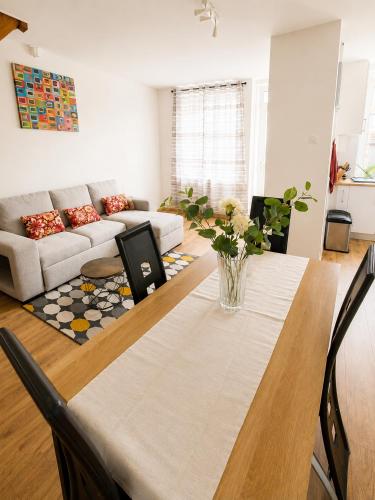 a living room with a table and a couch at Maison 6 pers - Entre mer & Mont-Saint-Michel in Beauchamps