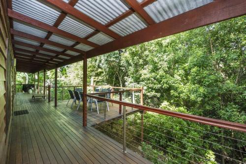 a wooden deck with a table and chairs on it at Magnetic Effect in Arcadia