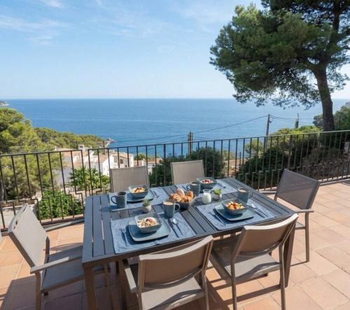 a blue table with food on it on a patio at La Terrasse 1-Vue Mer Panoramique & Piscine, BBQ in Begur