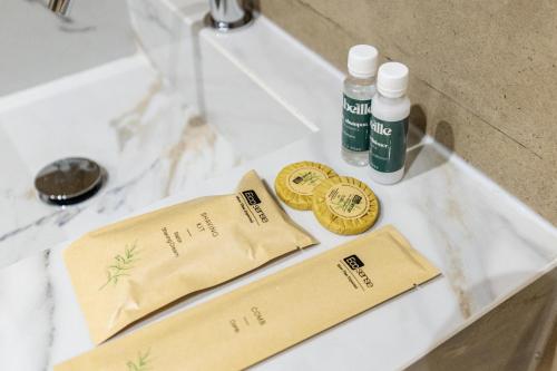 a counter with two bottles of cosmetics and a sink at Abeille Rooms in Himare