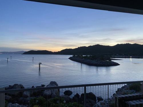 a view of a large body of water at sunset at 1 Bright Point Apartment 2303 in Nelly Bay